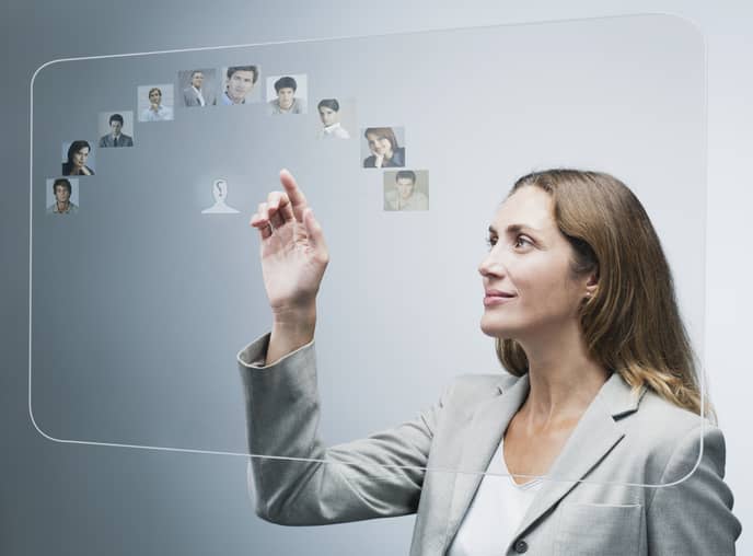 Human resources manager assessing candidates on advanced touch screen interface